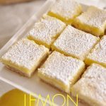 Lemon cheesecake bars on a cake stand