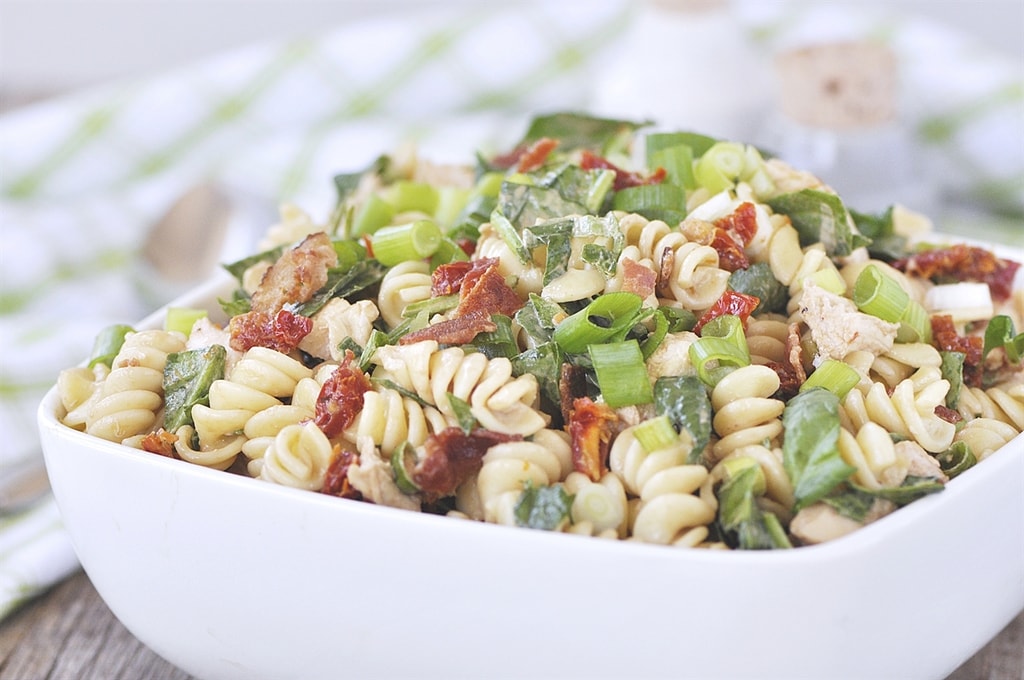 bowl of pasta salad with chicken bacon and sun dried tomatoe