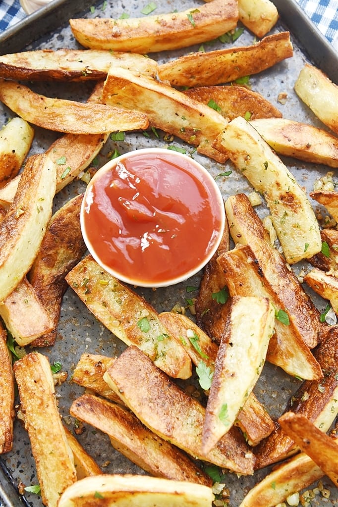 homemade garlic fries on a sheet pan with ketchup