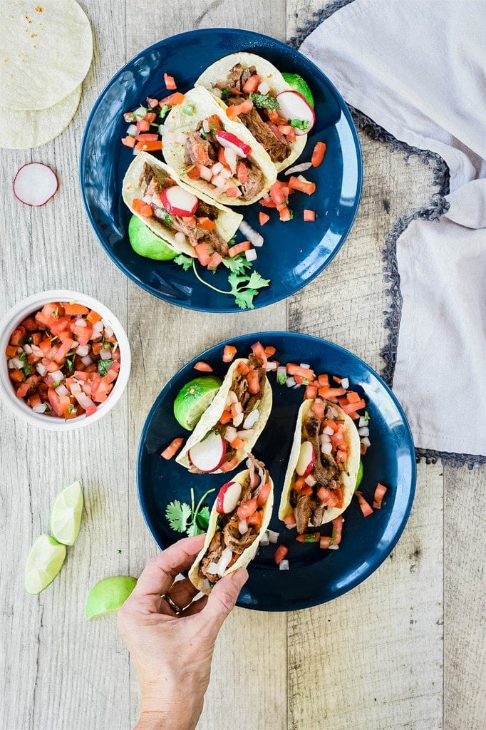 hand picking up a skirt steak taco