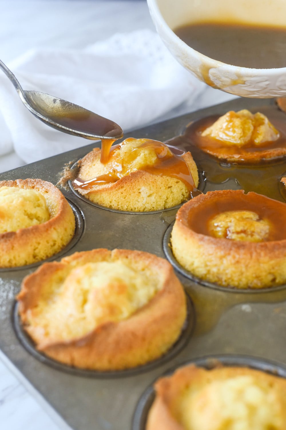 spooning glaze over marmalade muffins