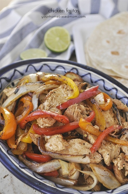 plate of chicken fajitas with bell peppers and onions