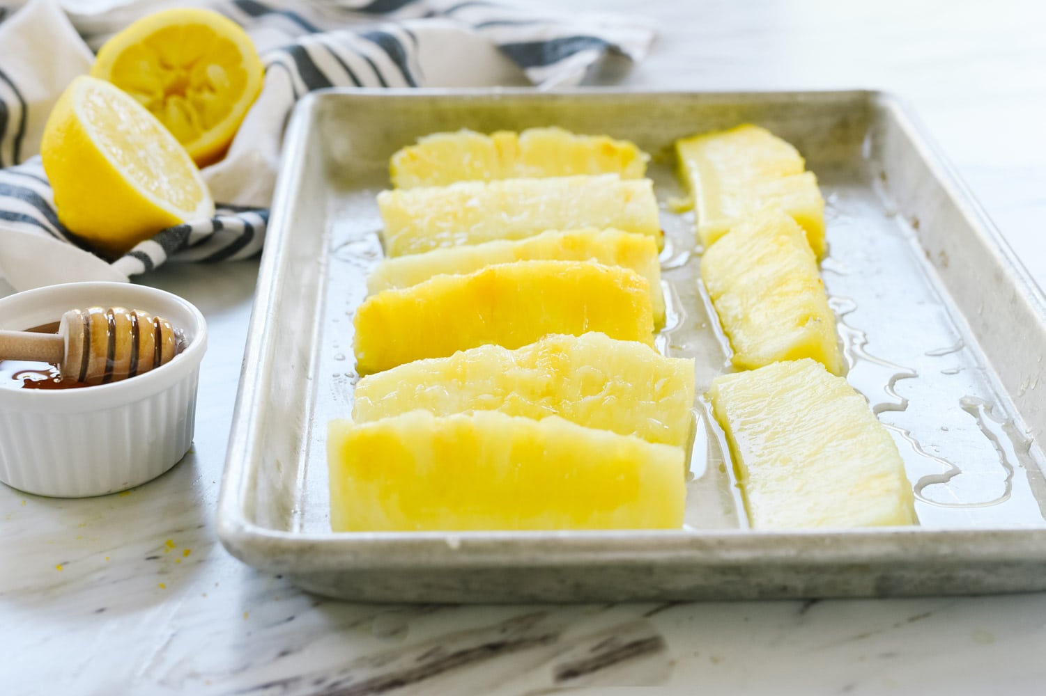 Pineapple spears on a baking sheet