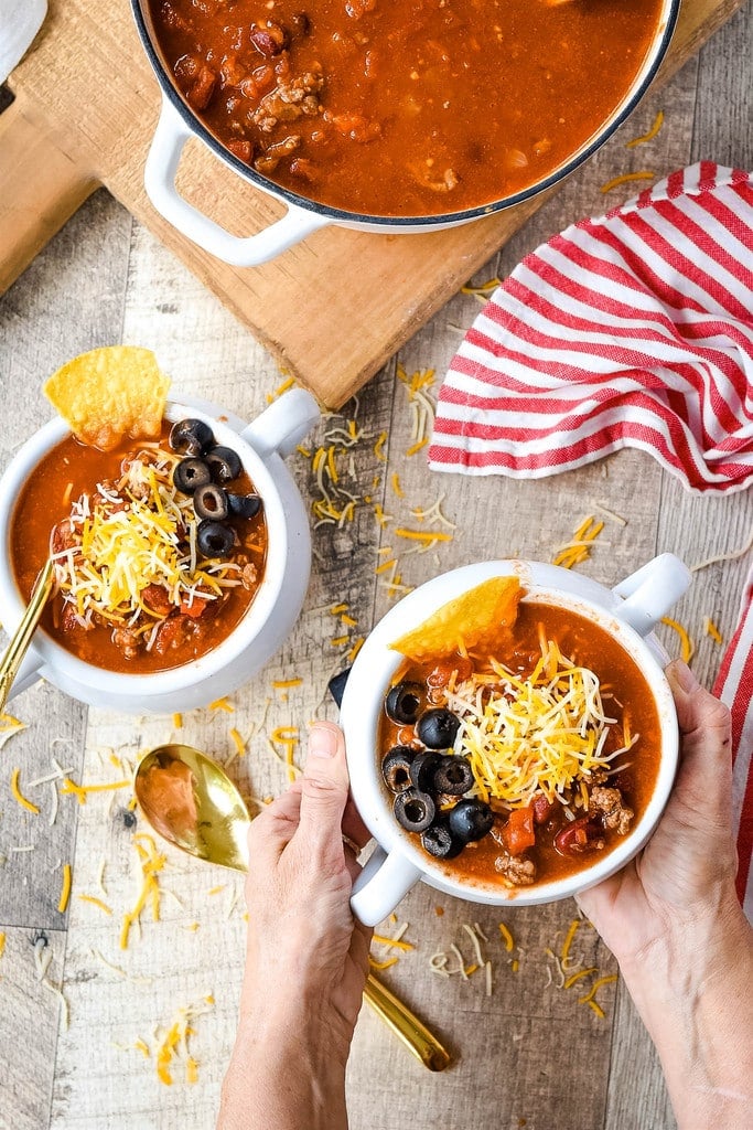 hands holding a bowl taco soup