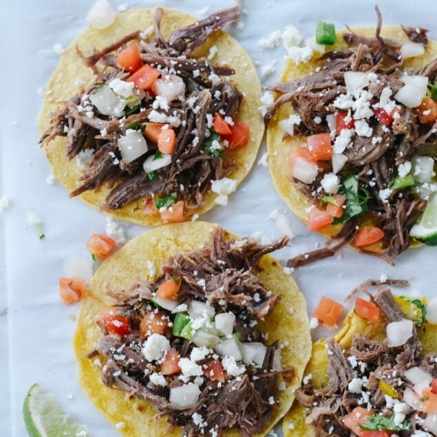 shredded beef tacos on corn tortillas