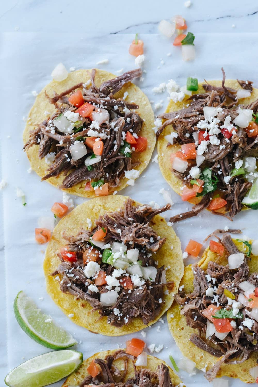 shredded beef tacos on corn tortillas