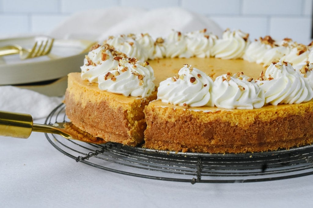 slice of pumpkin cheesecake on a spatula