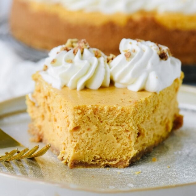 Slice of pumpkin cheesecake with a bite out of it