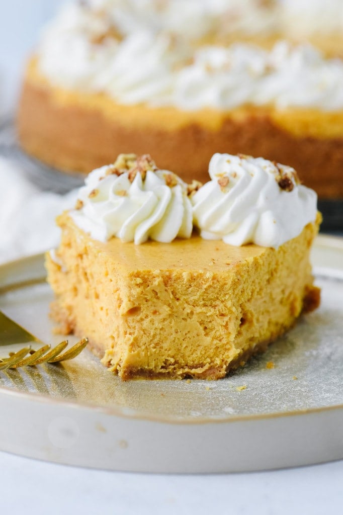 Slice of pumpkin cheesecake with a bite out of it