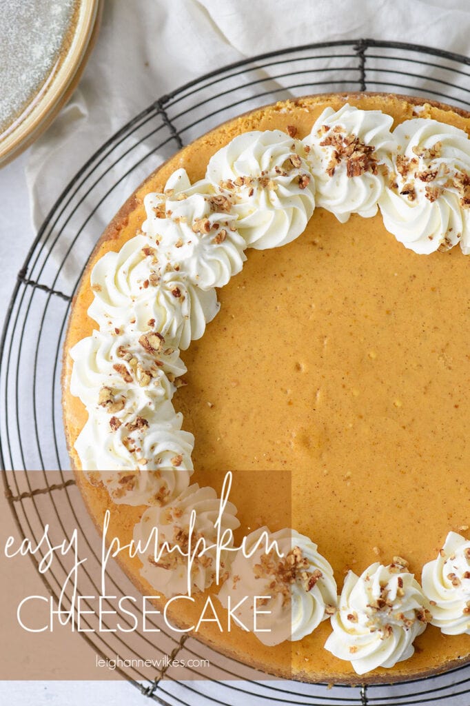 entire pumpkin cheesecake with whipped cream and pecans