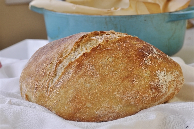 No Knead Bread Loaf cooling on white cloth