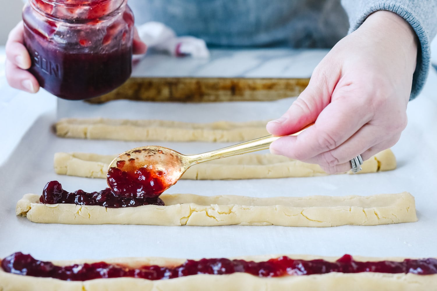 Putting jam on split second cookies