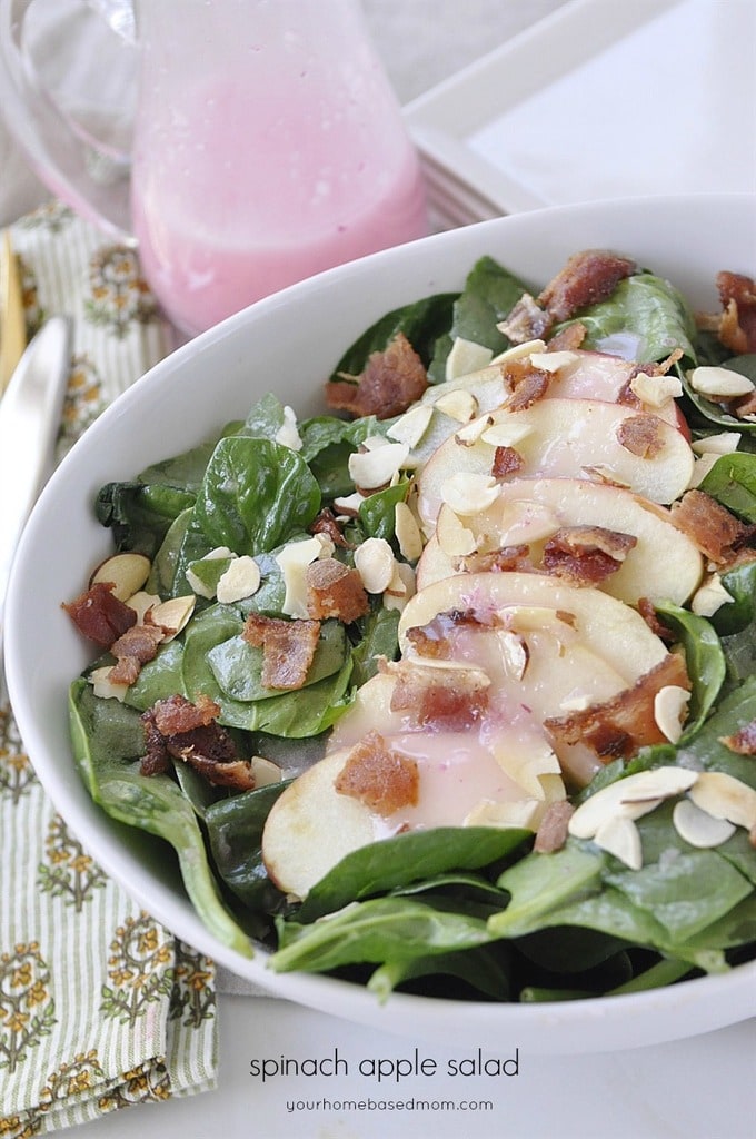 Spinach salad with sliced apples almonds and bacon