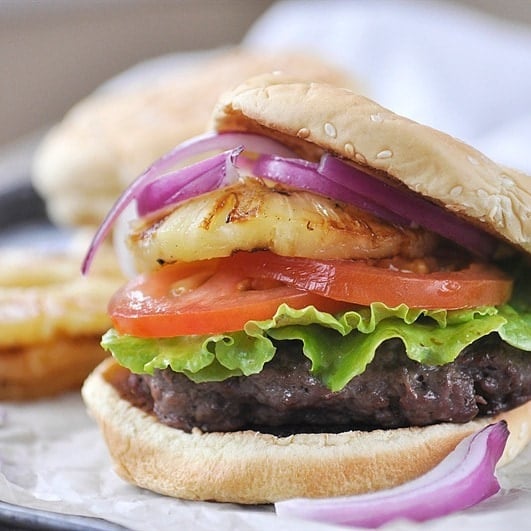 teriyaki burger with lettuce tomato onion and grilled pineapple