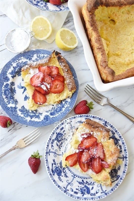 Sliced German Pancake swith strawberries and powdered sugar