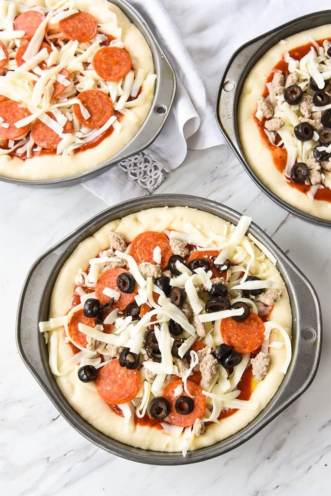 Deep Dish Pizza topped with pepperoni sausage and olives