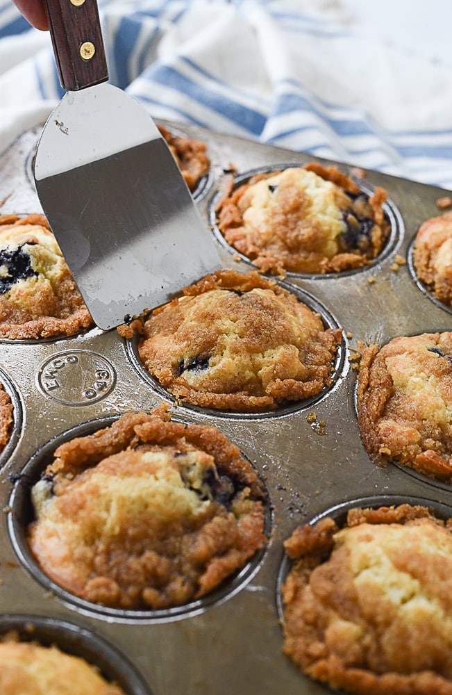 Streusel blueberry muffin recipe spatula on a muffin