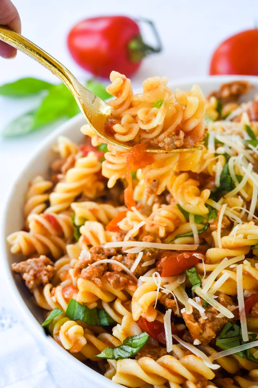 forkful of sausage and tomato pasta