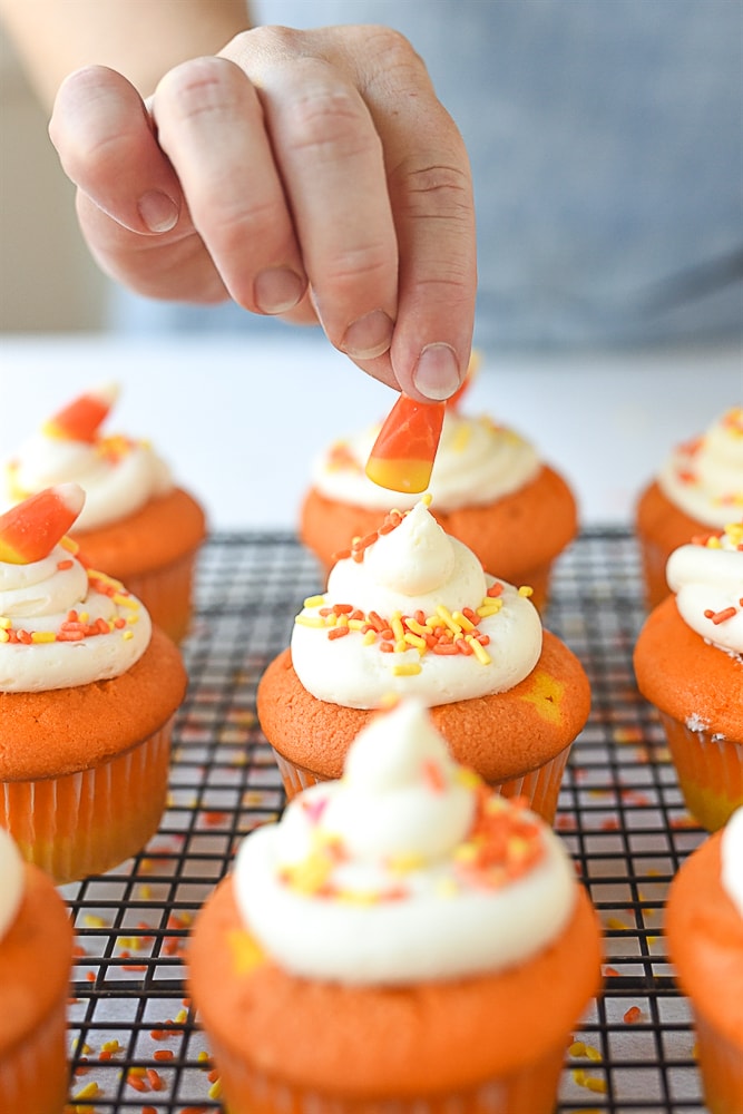 adding candy corn to a cupcake