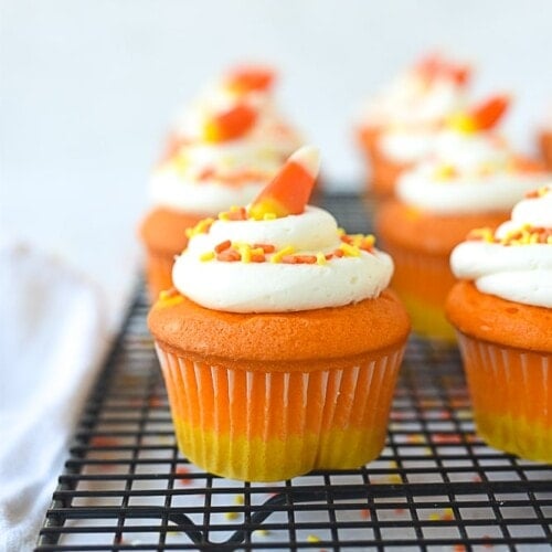 candy corn cupcake on a cooling rack