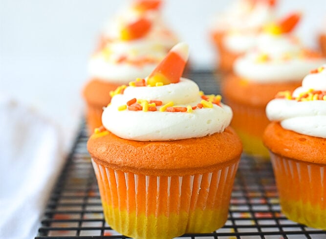 candy corn cupcake on a cooling rack