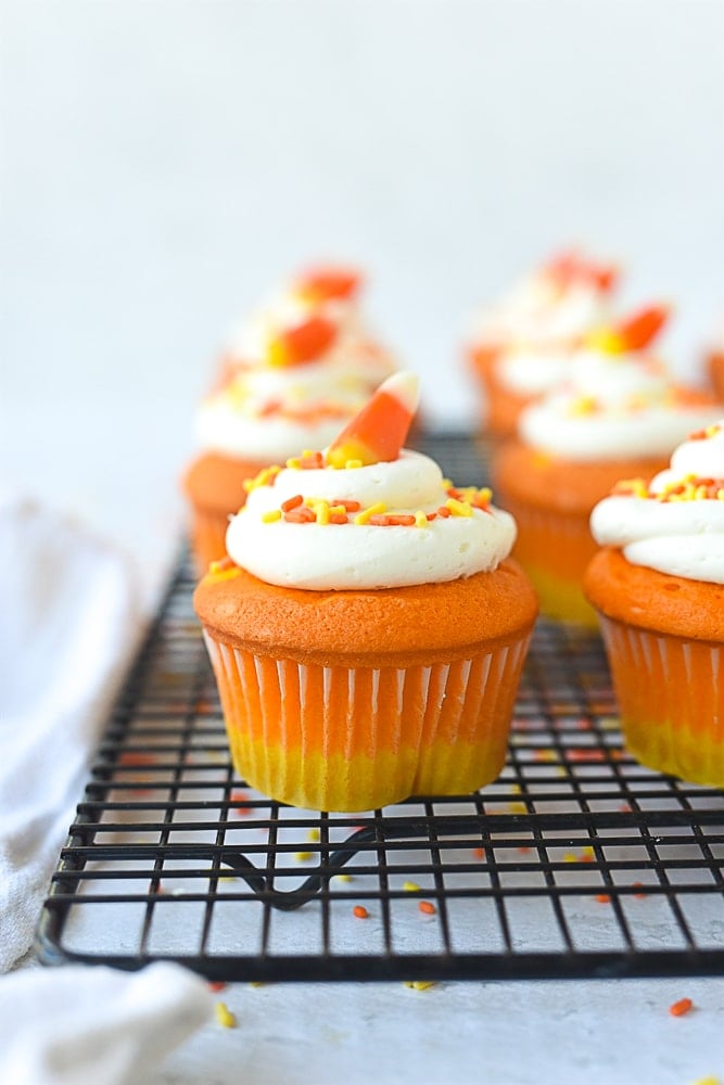 candy corn cupcake on a cooling rack