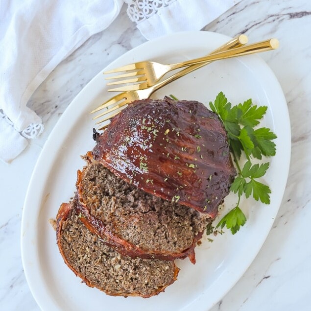 overhead shot of bacon wrapped meatloaf on a plate