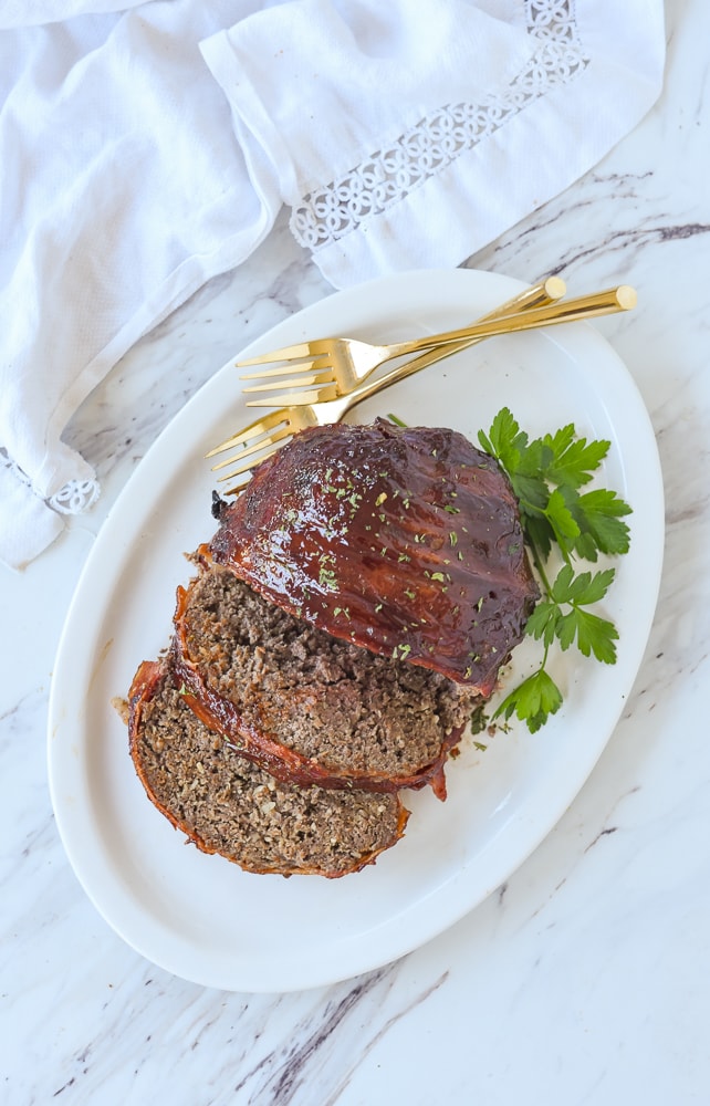 overhead shot of bacon wrapped meatloaf on a plate