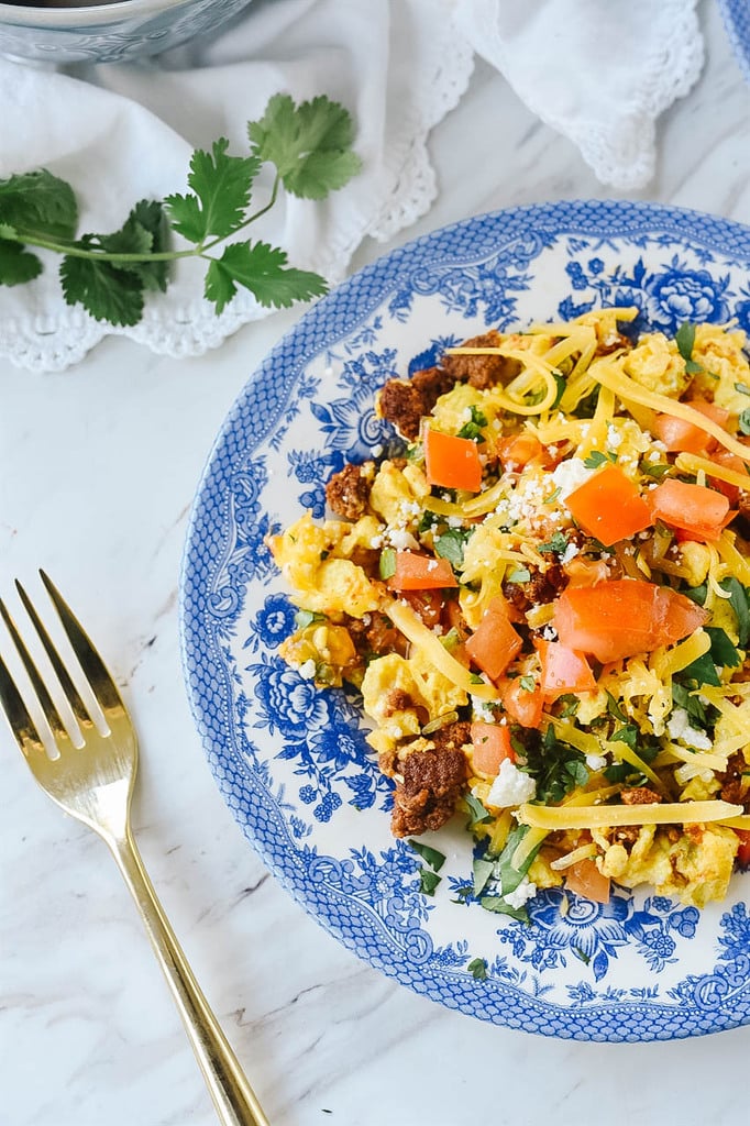 chorizo and eggs on blue and white plate
