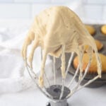 mixer whisk with maple frosting on it