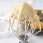 mixer whisk with maple frosting on it