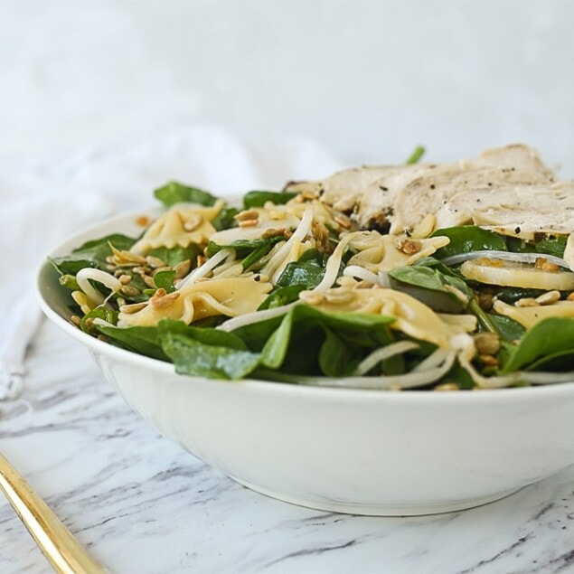 bowl of spinach salad with pasta