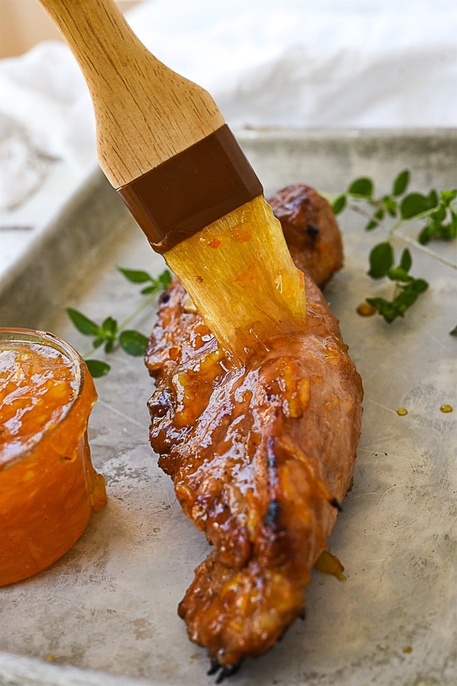 brushing pork with orange marmalade