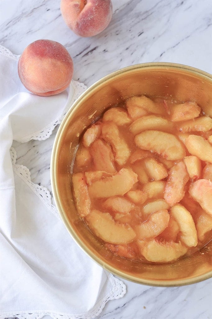 Fresh peaches peeled and sliced in a bowl