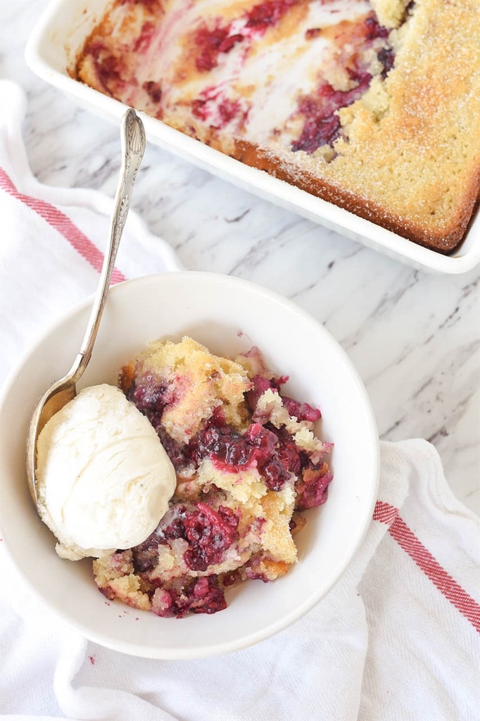 bowl of marionberry cobbler with vanilla ice cream