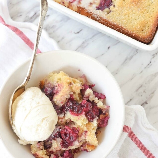 bowl of marionberry cobbler with vanilla ice cream