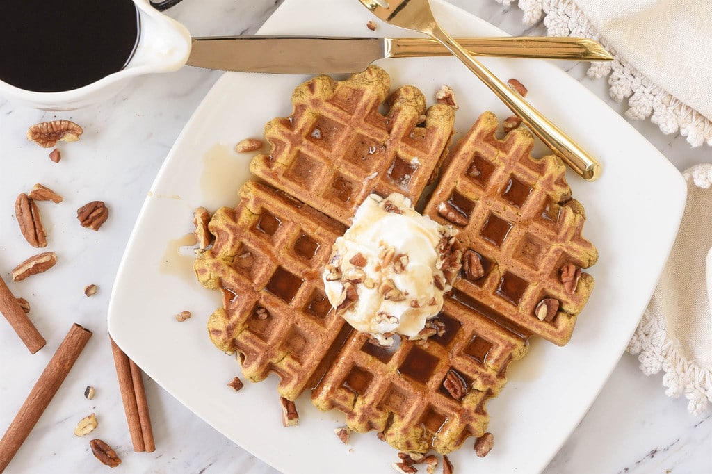 pumpkin waffles with syrup whipped cream pecans