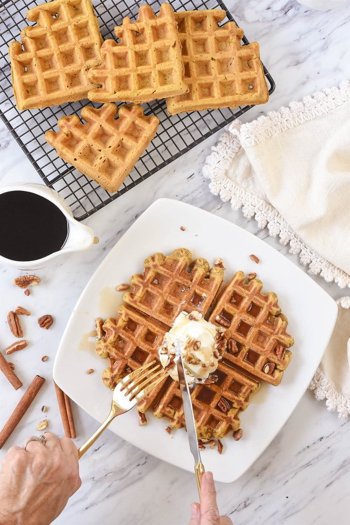 cutting into pumpkin waffles