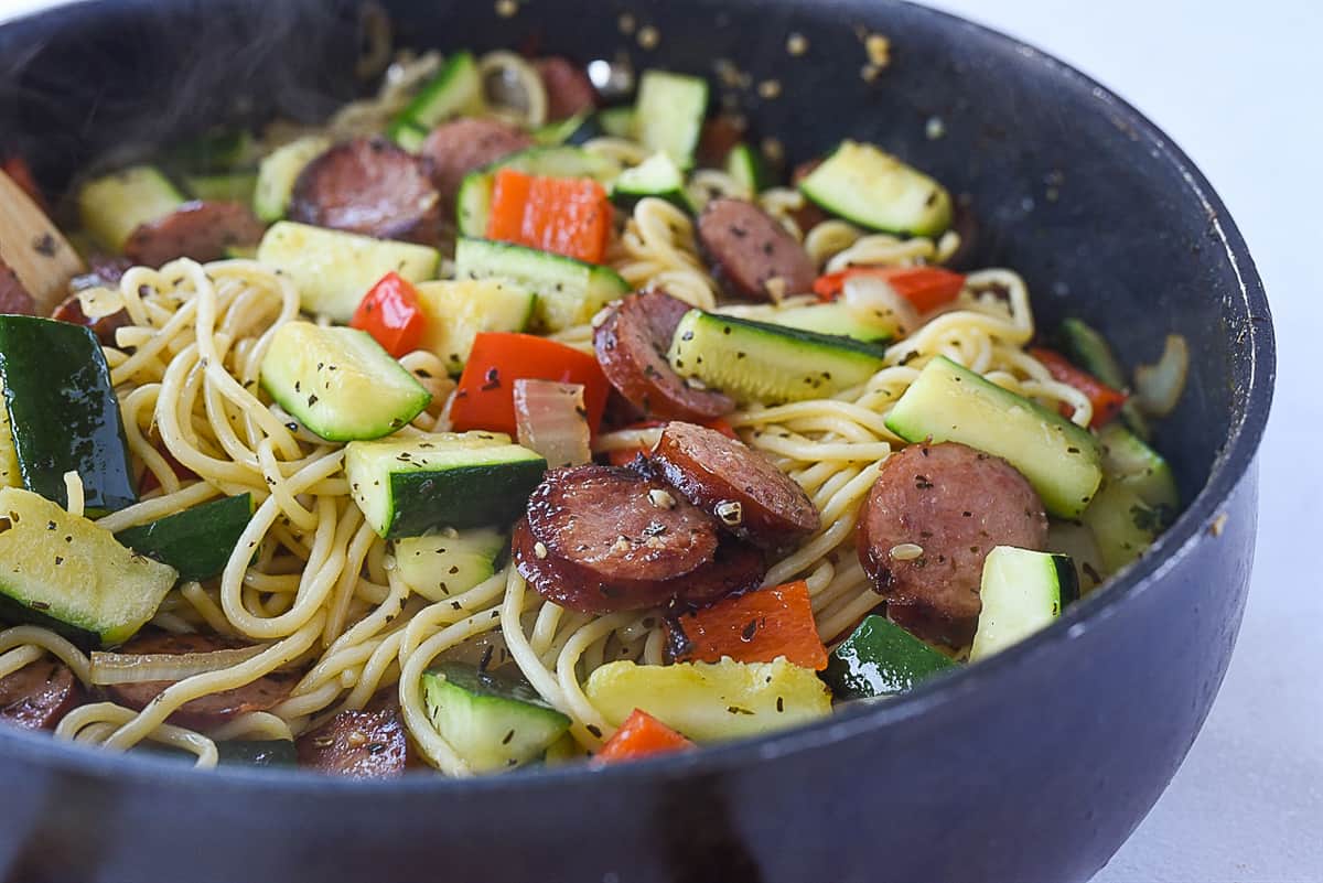 adding vegetables into frying pan