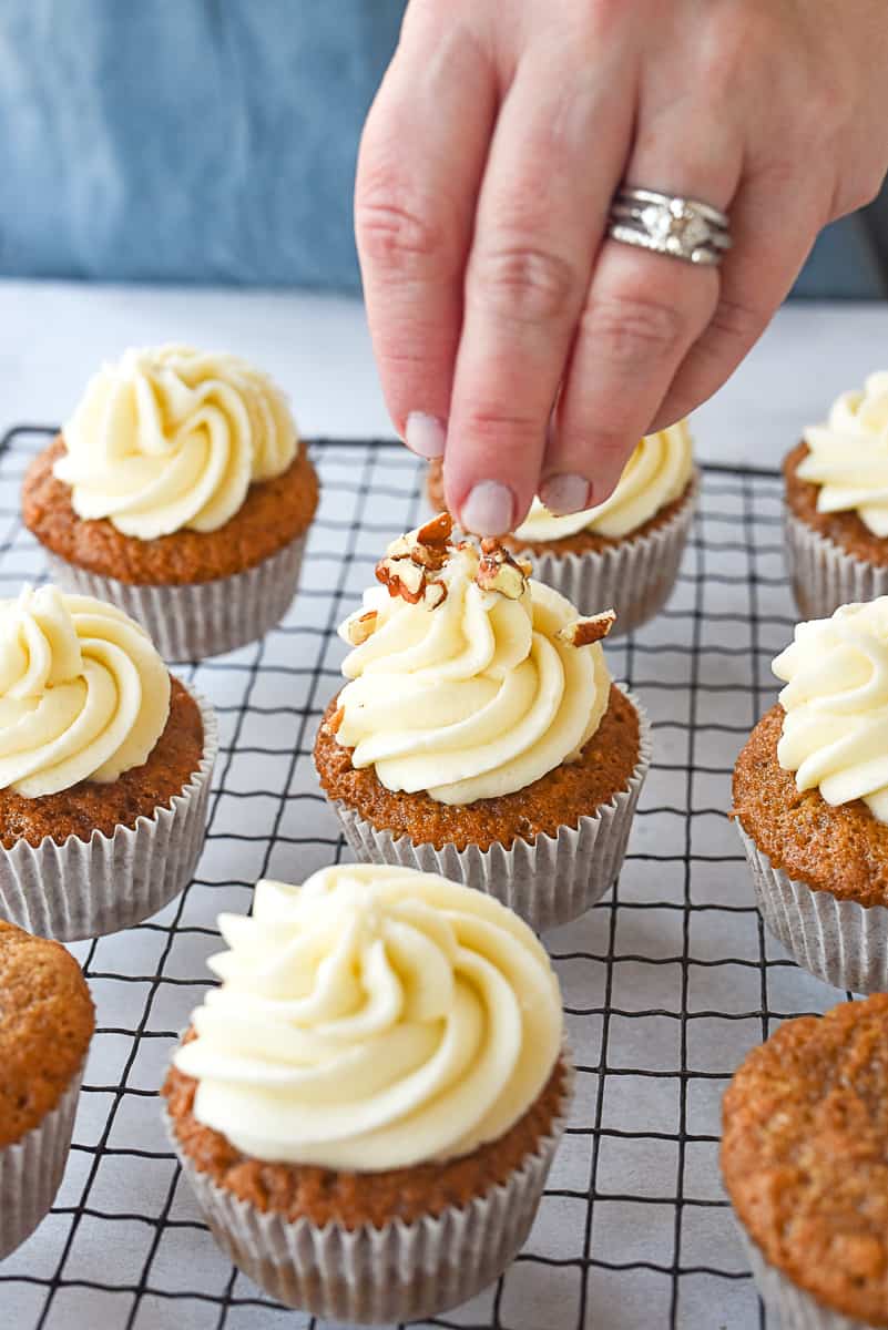 sprinkling nuts on cupcakes