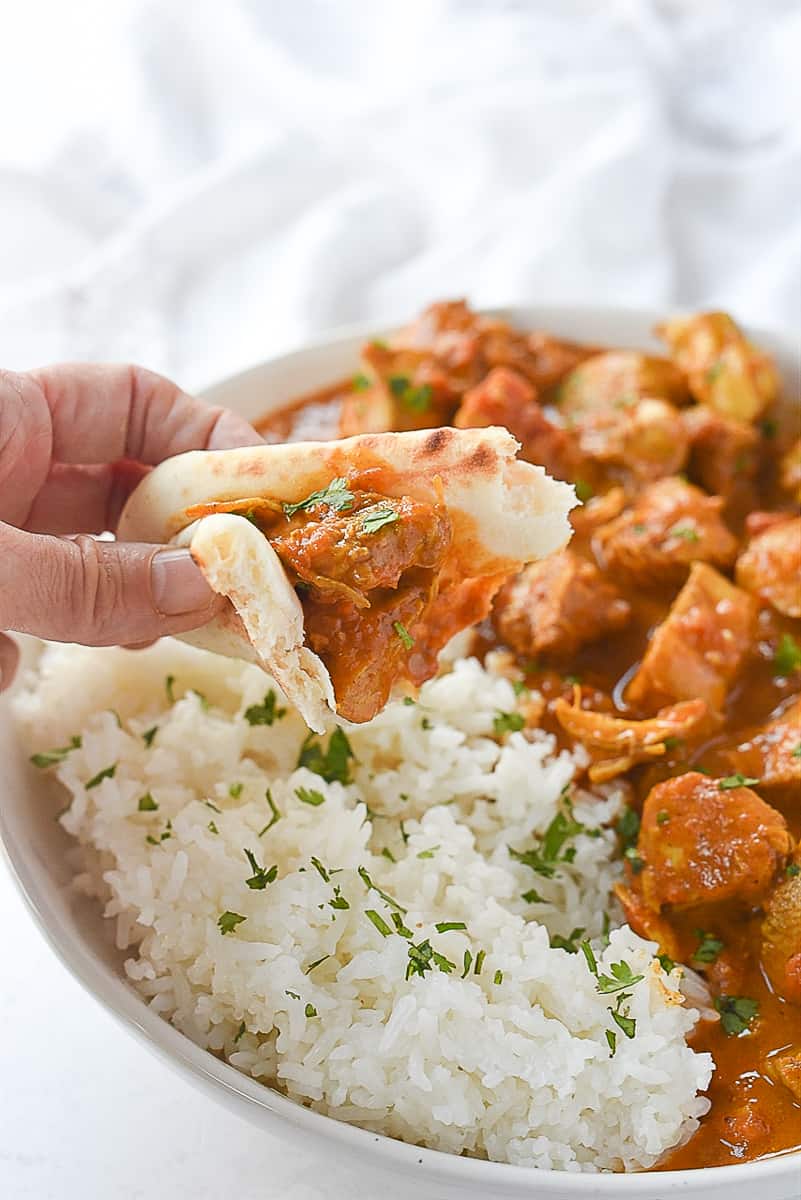 naan bread scooping up chicken tikka masala