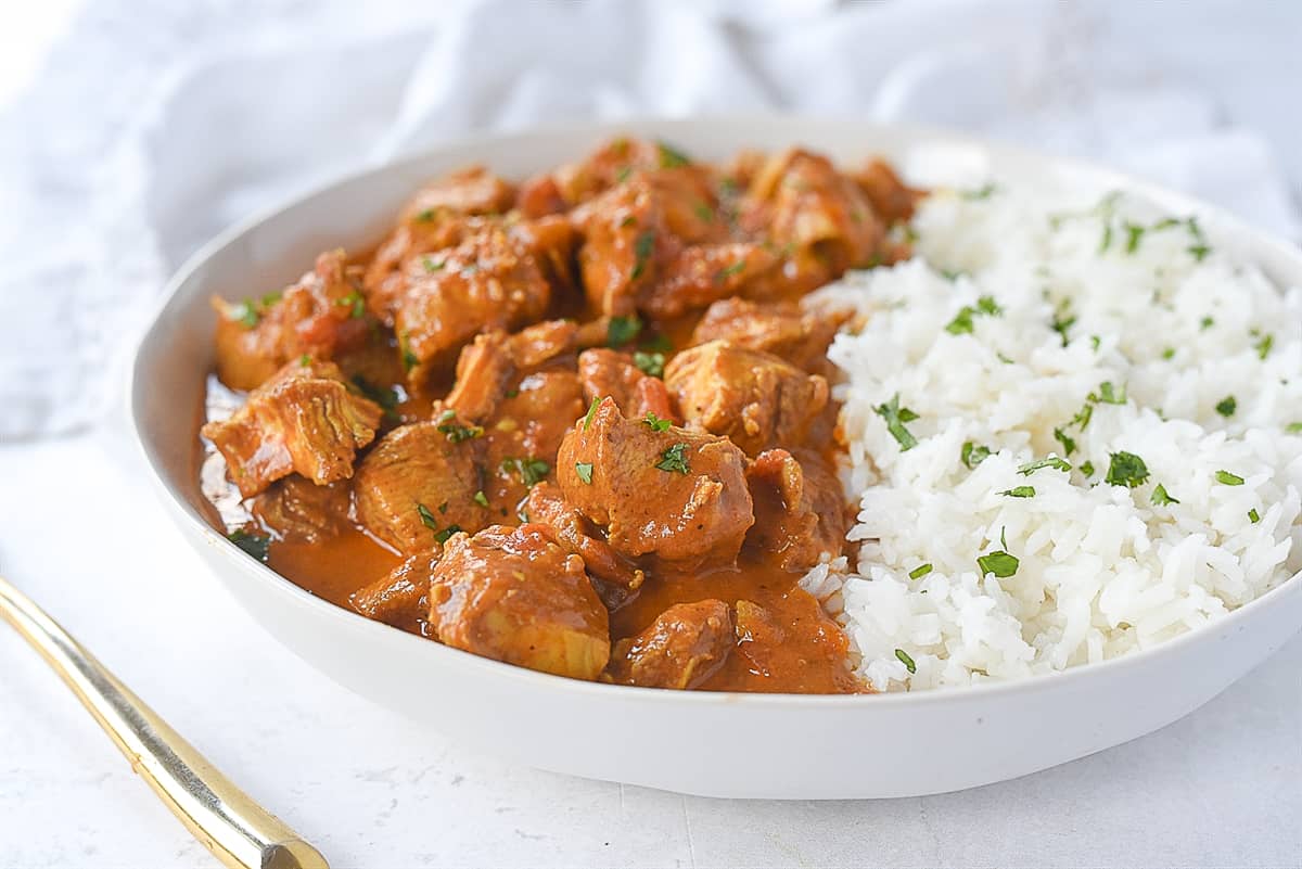 chicken tikka masala and rice in a bowl.