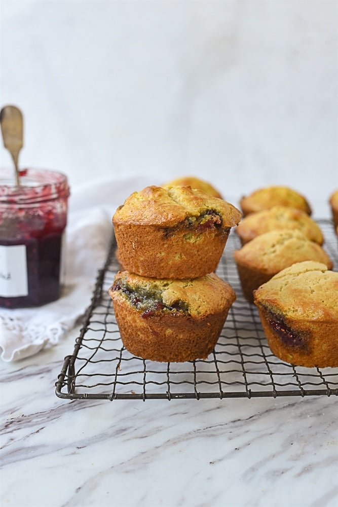 a pile of muffins on a cooling rackk