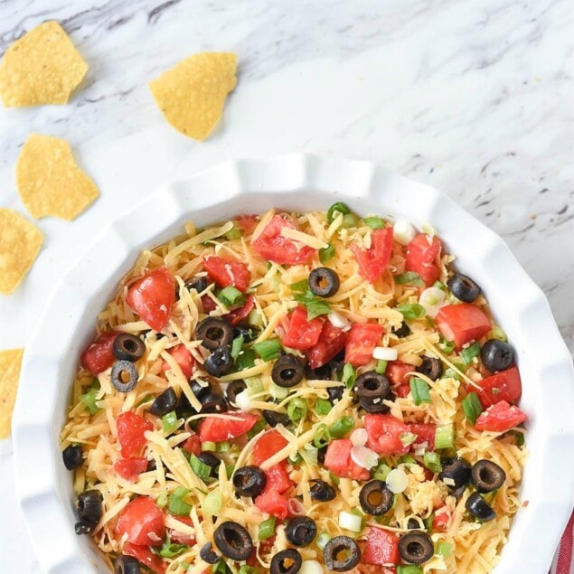seven layer dip in a white dish