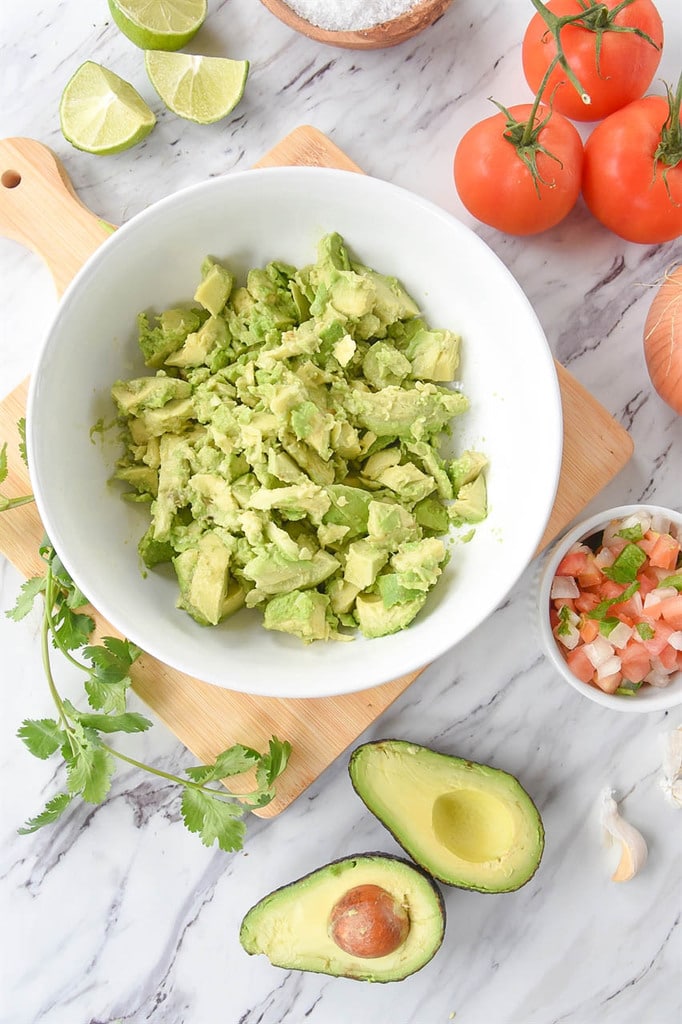 Diced avocado, limes, tomatoes, onions, and cilantro