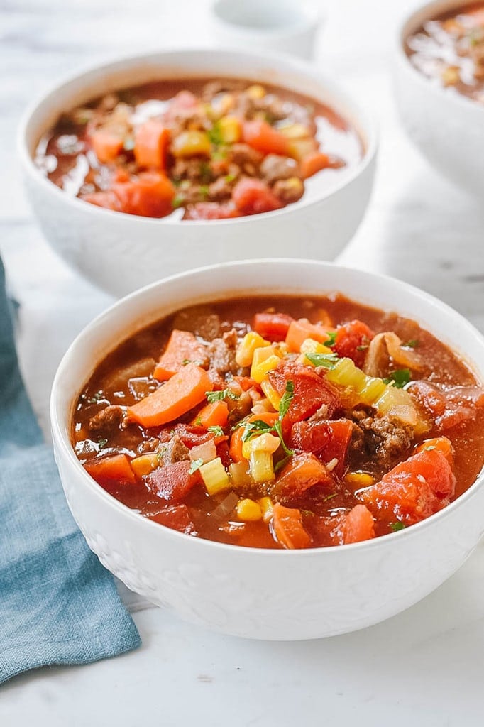 hamburger soup in white bowls