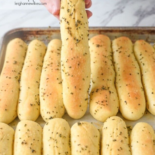 hand holding an olive garden bread stick