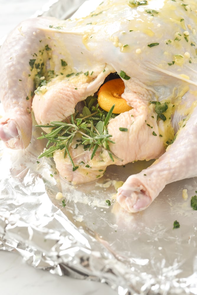 herbs and lemons in a chicken