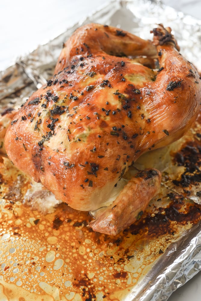 whole roasted chicken on a baking sheet