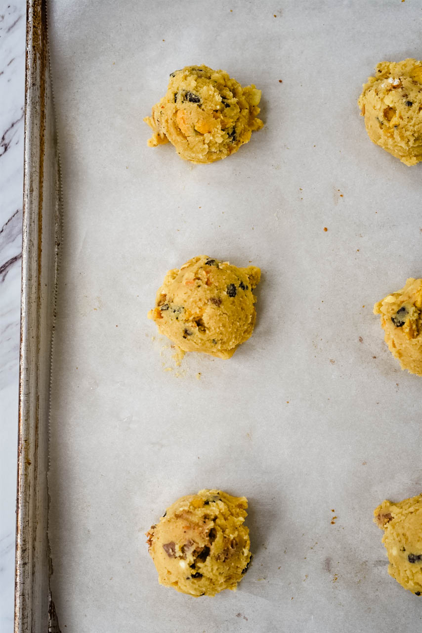 scoops of cookie dough on baking sheet